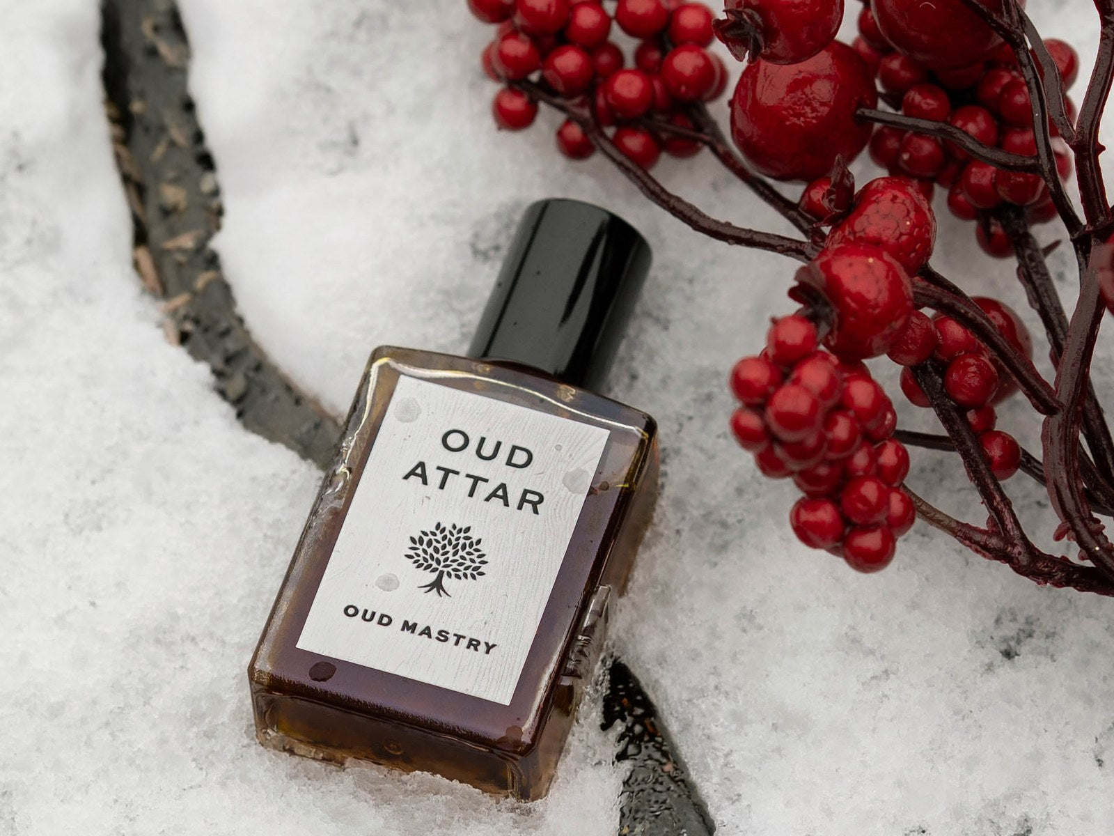 Oud Mastry bottle in snow with red winter berries