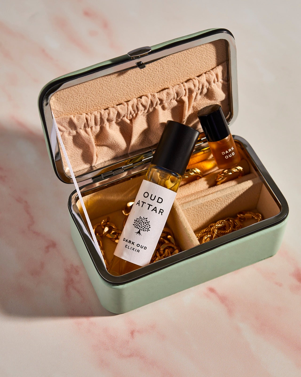 Dark Oud elixir and 2ml mini packed in an open travel case