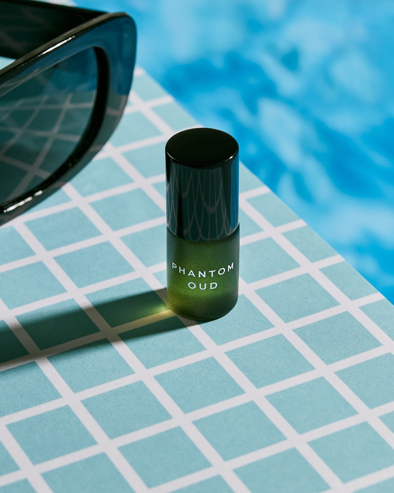 Phantom Oud mini standing poolside on turquoise tiles
