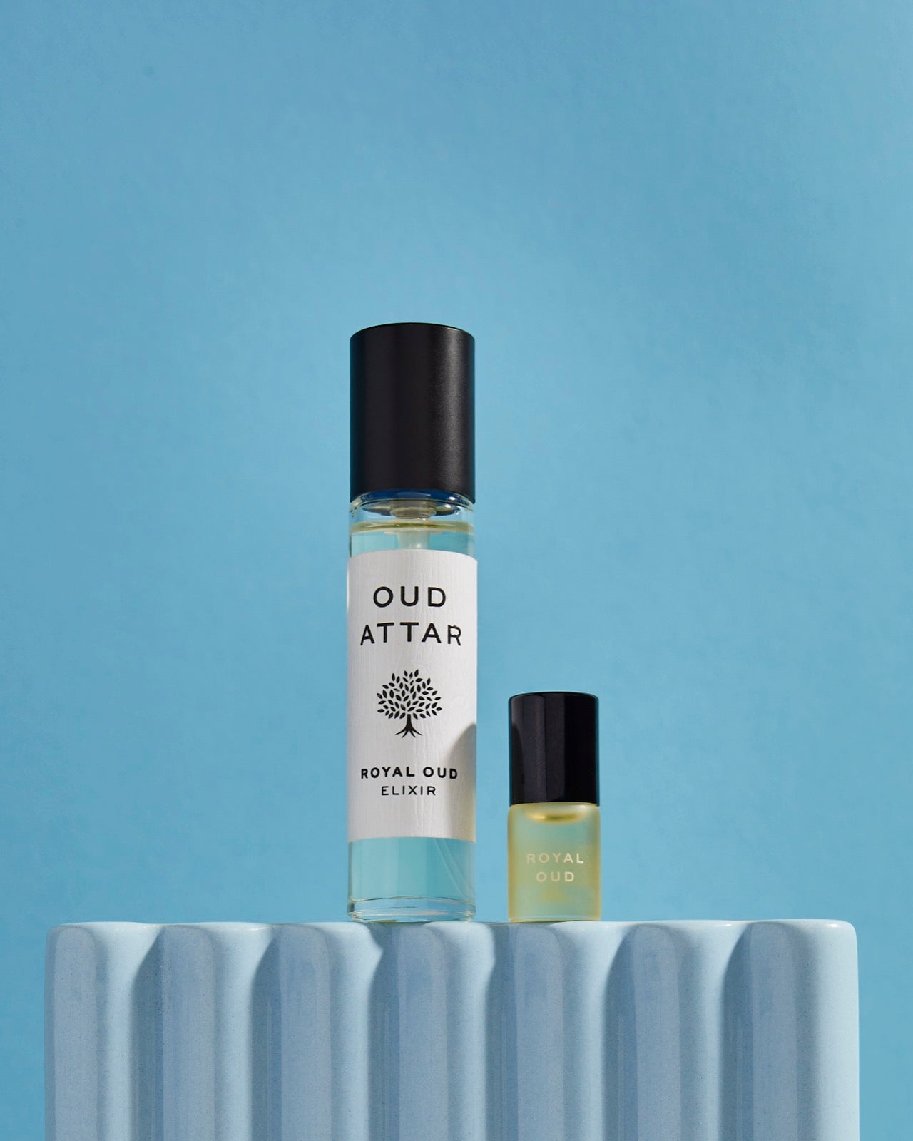 Royal Oud 10ml with a 2ml mini on a fluted podium