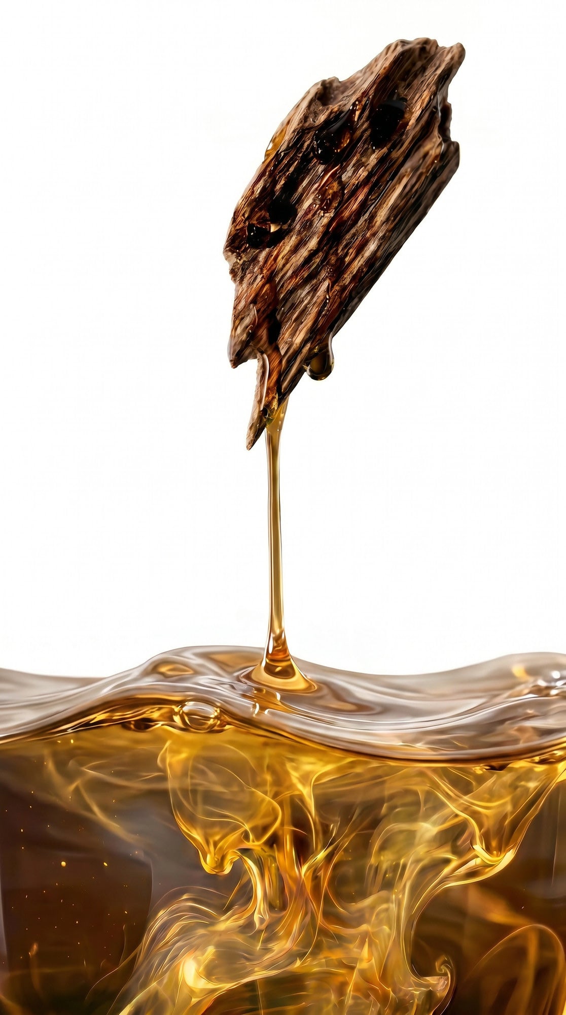 Oud oil dripping from a wild oud chip