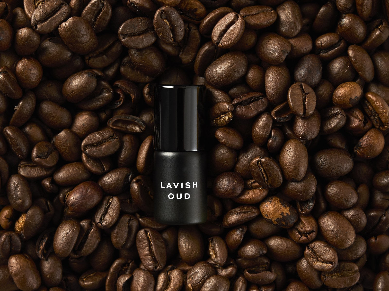 Lavish Oud rollerball on a bed of coffee beans