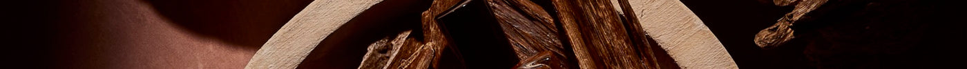 Oud Attar bottles nestled in bowls of oud chips