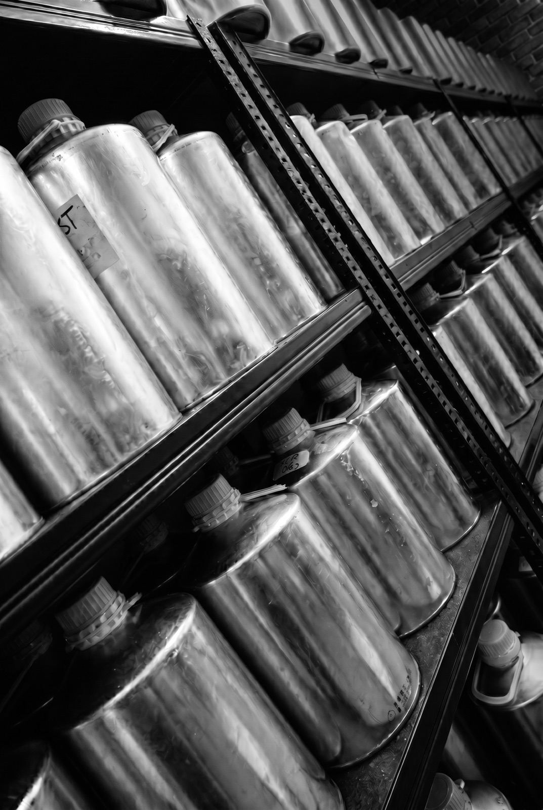 Shelves of sealed oud maturing cans