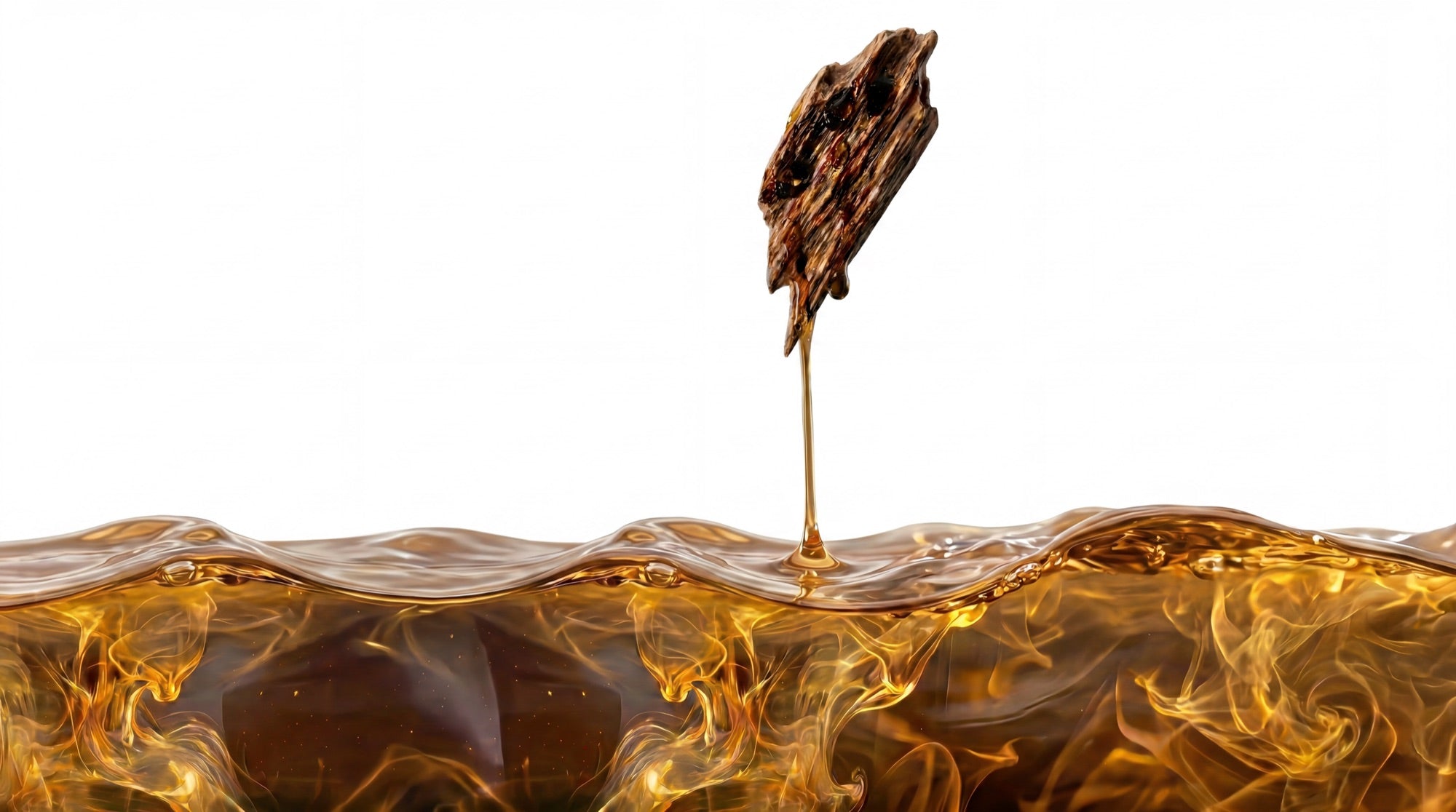 Oud oil dripping from aged wood into pooled oil